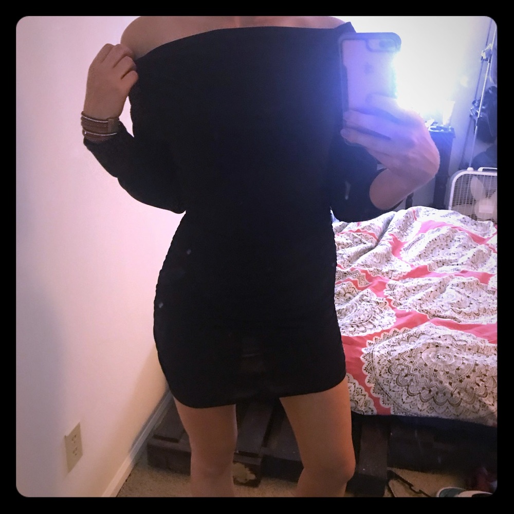 Form fitting black dress with shoulder cutout